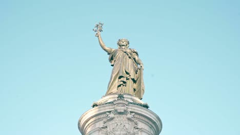 Detail-view-of-the-statue-of-Marianne-symbolizing-peace-and-human-rights,-main-symbol-of-the-Place-de-la-Republique,-Paris,-France
