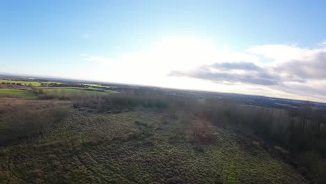 FPV-drone-flying-across-Billinge-hill-beacon-autumn-Lancashire-woodland-landscape