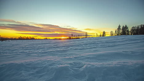 Majestic-Golden-Orange-Sun-Rising-On-Horizon-Above-Winter-Snow-Landscape