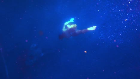 A-man-freediving-deeper-and-deeper-into-the-blue-ocean