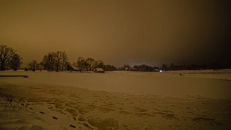 Local-snowy-rural-village-with-bright-lights,-misty-sky,-fusion-time-lapse