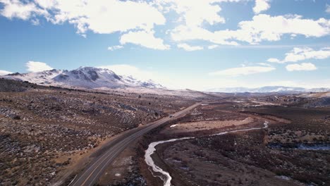 drone-fly-above-Sierra-Nevada-scenic-mountains-landscape-with-snowy-mountains-peaks-during-sunny-day