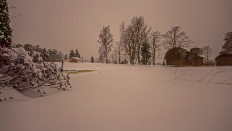 Static-shot-of-wooden-cottages-covered-with-thick-layer-of-white-snow-on-a-cold-winter-cloudy-day-in-timelapse