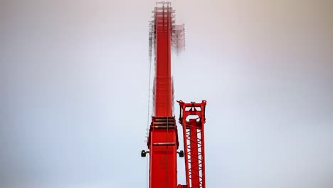 A-construction-crane-extending-into-the-sky-on-an-overcast-day---time-lapse