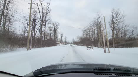 Car-stuck-in-snow-POV-From-Inside-Car-Driving-Along-Snow-Covered-Road-In-Fort-Erie,-Ontario-In-Canada
