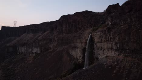 Scenic-aerial-cinematic-footage-of-Frenchmen-coulee-waterfall-in-Washington-state-during-sunset,-drone-approaching-canyon-rock-formations