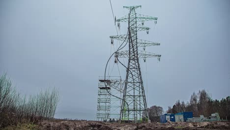 Erecting-a-scaffold-to-repair-an-electrical-transmission-tower---winter-time-lapse
