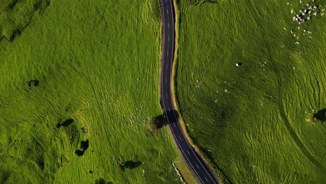 Aerial-top-down-of-asphalted-switchback-road-street-in-green-hills-countryside,-clean-environment-natural-energy-no-pollution-concept-aerial-cinematic-eye's-bird-view