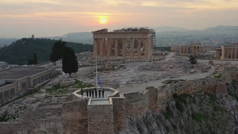 Aerial---Lowering-the-Greek-flag-in-Acropolis-of-Athens,-Greece