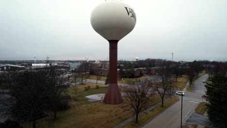rising-drone-shot-of-a-water-tower-in-Vernon-Hills,-Illinois-on-a-rainy-day-4k