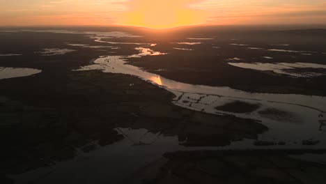 Aerial-view-of-the-sun-setting-over-Ireland's-beautiful-landscape