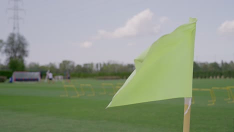 Waving-flag-in-slow-motion-shot-on-soccer-training-grounds