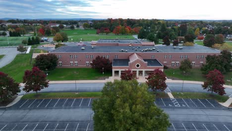 Aerial-truck-shot-of-small-elementary-school-in-autumn
