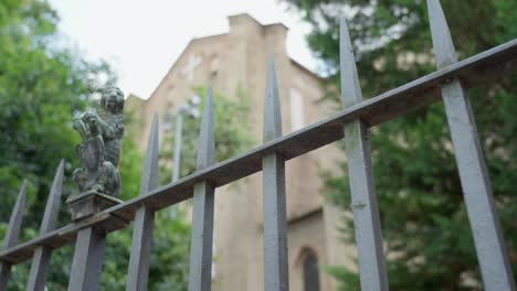 Iron-fence-with-lion-figurine-in-wide-dolly-shot-outside-church