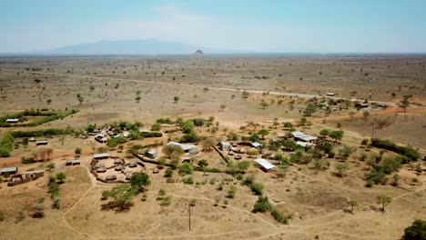 Panoramic-aerial-view-of-a-village-of-Karamoja,-also-known-as-Manyatta-or-Ere,-on-a-sunny-day-in-Uganda,-Africa