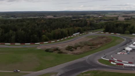 Aerial-pan-following-indycars-at-racetrack-in-Sweden