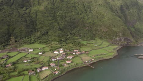 Aerial-pullback-reveals-epic-Fajã-da-Caldeira-de-Santo-Cristo,-wildlife-park