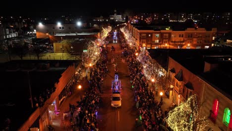 Cinematic-drone-shot-of-Christmas-parade-celebration,-Colorado