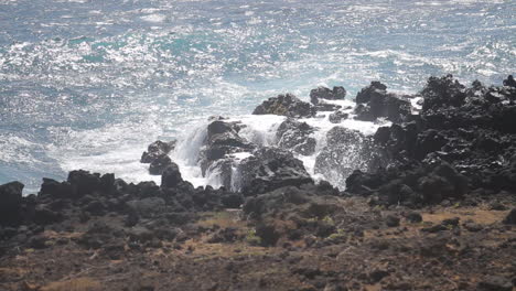 Waves-Crash-Against-Shore-on-Black-Rocks-Beach-in-Hawaii