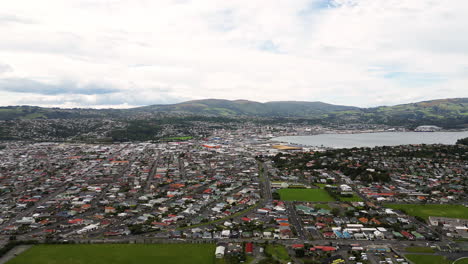 Aerial-cityscape-of-urban-area-in-Dunedin-city-in-New-Zealand,-at-the-head-of-Otago-Harbour-on-the-South-Island’s-southeast-coast