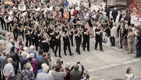 Orchestra-marching-in-Molde-Jazz-festival,-handheld-motion-view
