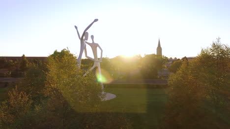 Dancers-Sculpture-at-Denver-Center-For-Performing-Arts,-Outdoors-Urban-Contemporary-Statue-Monument-in-Park-at-Sunset