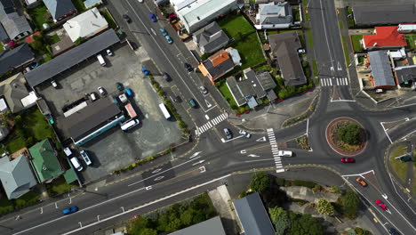 Dunedin-city-building-rooftops-and-streets-with-cars,-aerial-top-down-view