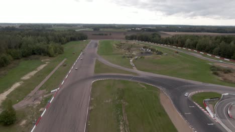 Rapid-aerial-following-racecars-during-race-at-racetrack-in-Sweden