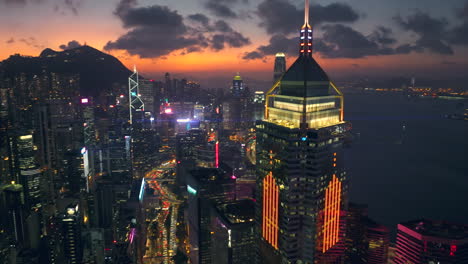 Aerial-drone-shot-approaching-towards-Central-Plaza,-Wan-Chai-district-in-Hong-Kong-with-stunning-evening-afterglow