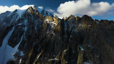 Cinematic-rotating-epic-drone-shot-of-a-large-mountain-top-in-the-Ak-Sai-glacier-in-Kyrgyzstan