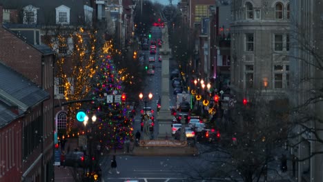 Long-aerial-zoom-rising-shot-of-Main-Street-of-Lancaster-Pennsylvania-during-Christmas-snow