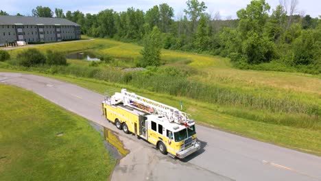 Ladder-firetruck-backing-up-onto-road-during-fire-drill-training-–-aerial-view