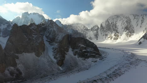 Cinematic-aerial-drone-shot-going-through-a-wide-opening-in-the-Ak-Sai-glacier-in-Kyrgyzstan