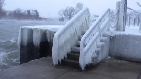 Wide-static-shot-of-a-frozen-staircase-during-a-winter-storm