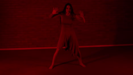 Emotional-and-charismatic-female-dancer-dancing-in-red-lighting
