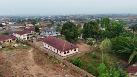 Aerial---forward-tilt-down-shot-of-an-African-town-house-in-a-sprawling-neighborhood