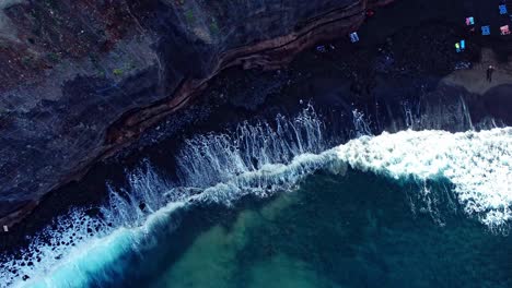 Top-View-Of-Waves-Fading-Smoothly-On-Rocky-Beach,-Tenerife,-Spain