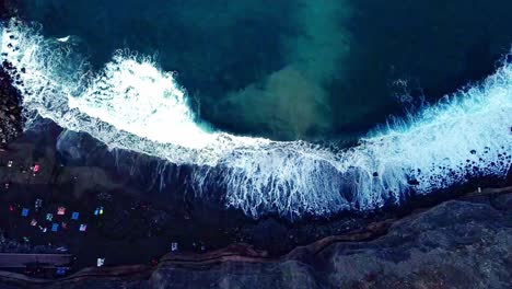 Overhead-Shot-Of-Waves-Fading-Smoothly-On-Rocky-Beach,-Tenerife,-Spain
