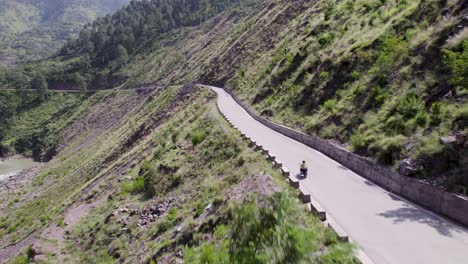 Aerial-shot-of-solo-female-bike-rider-in-the-valley