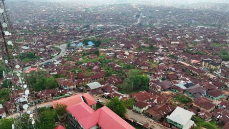 Aerial---Forward-tilt-down-shot-of-Ibadan-metropolis-with-brown-roof