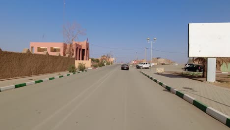 Driving-behind-a-convertible-Porsche-Boxster-in-a-Moroccan-desert-village