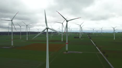 Clean-Energy-in-Motion:-Spinning-Windmills-Generating-Sustainable-Power-on-a-Cloudy-Day-in-North-Rhine-Westphalia-near-Bad-Wünnenberg,-Paderborn-,-Germany
