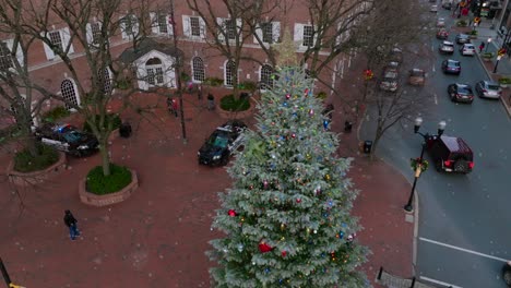Aerial-of-snow-falling-on-Christmas-tree-in-Lancaster-PA-town-square