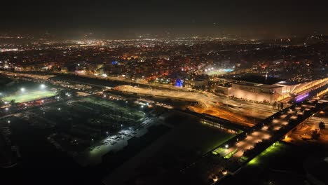 Drone-footage-of-illuminated-urban-highway-at-night