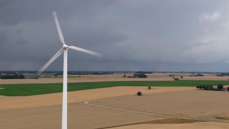 Aerial-pull-in-towards-wind-turbine-in-Swedish-farming-area