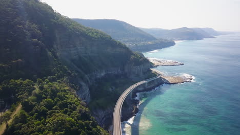 Epic-driving-bridge-on-ocean-Australia-SeaCliff-Bridge-Summer-forward-Drone-Stunning-summer-day-drone-cinematic-by-Taylor-Brant-Film
