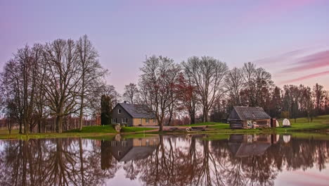 Two-beautiful-cottages-in-the-countryside-reflecting-on-a-lake