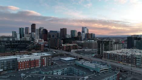 Aerial-Panoramic-View-of-Denver-City-Colorado-at-Sunset,-Residential-Neighborhood-and-Stadium-Next-to-Downtown-District