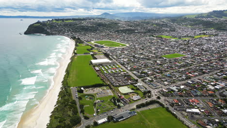 Dunedin-city-and-Saint-Clair-Beach-from-above,-New-Zealand-coastline-in-aerial-view