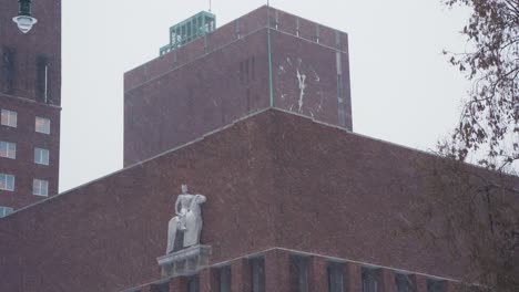 Winter-Corner-View-Of-Oslo-City-Hall-With-Statue-of-King-Charles-John-And-Clock-Face-On-Top